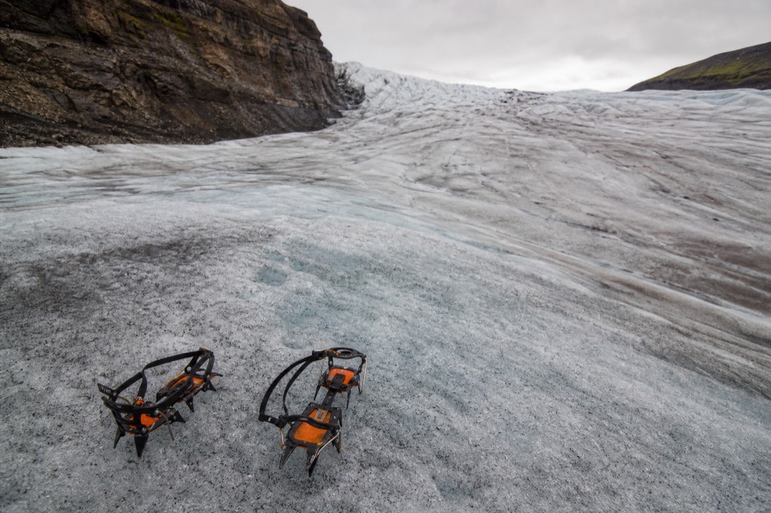 A guide showing beginners how to walk in crampons on the lower ice of Falljökull glacier near Skaftafell, Iceland